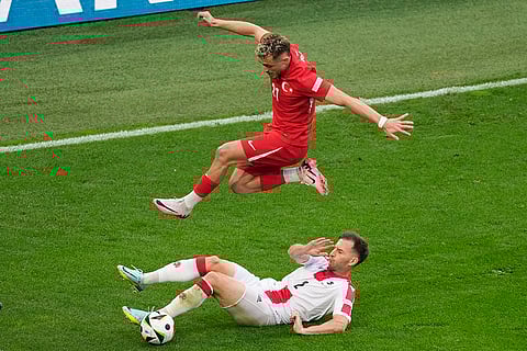 Baris Alper Yilmaz challenges for the ball with Otar Kakabadze